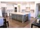 Spacious kitchen with white cabinets, a large island, stainless steel appliances, and hardwood floors at 4881 Belle Estates Rd, Suwanee, GA 30024
