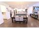 Open-concept kitchen and dining area with a large kitchen island and adjacent dining table at 4881 Belle Estates Rd, Suwanee, GA 30024