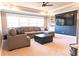 Comfortable living room with a plush sectional, ottoman, and large windows for natural light at 4881 Belle Estates Rd, Suwanee, GA 30024