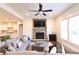 Comfortable living room featuring a stone fireplace, TV, and a sectional sofa with decorative pillows at 4881 Belle Estates Rd, Suwanee, GA 30024