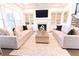 Cozy living room with built-in shelves, a fireplace, and comfortable sofas at 4881 Belle Estates Rd, Suwanee, GA 30024