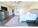 Elegant main bedroom with tray ceilings, stylish furnishings, and a relaxing atmosphere at 4881 Belle Estates Rd, Suwanee, GA 30024
