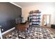 Well-lit office space featuring a stylish desk, modern shelving, and a patterned rug at 4881 Belle Estates Rd, Suwanee, GA 30024