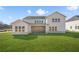 Stunning back exterior view of home featuring a covered patio and ample windows at 5130 Travers Ln, Cumming, GA 30040