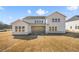Stunning back exterior view of home featuring a covered patio and ample windows at 5130 Travers Ln, Cumming, GA 30040