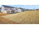 Backyard view of new construction homes with lawn that is ready for customization and enjoyment at 5130 Travers Ln, Cumming, GA 30040