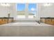 Bright bathroom featuring a soaking tub, double vanities, and natural light from a large window at 5130 Travers Ln, Cumming, GA 30040