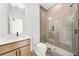 Modern bathroom featuring a walk-in shower, vanity, and light fixtures at 5130 Travers Ln, Cumming, GA 30040
