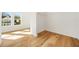 Sunlit bedroom boasts beautiful hardwood floors, white walls, and view to exterior at 5130 Travers Ln, Cumming, GA 30040