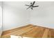 Bright bedroom with hardwood floors, ceiling fan, and a closet at 5130 Travers Ln, Cumming, GA 30040