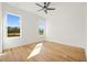 Sun-filled bedroom with hardwood floors and two windows overlooking the neighborhood at 5130 Travers Ln, Cumming, GA 30040
