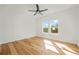 Bright, spacious bedroom with hardwood floors, ceiling fan, and a large window at 5130 Travers Ln, Cumming, GA 30040