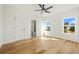Comfortable bedroom with hardwood floors, a ceiling fan, and a view of outdoors at 5130 Travers Ln, Cumming, GA 30040