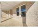 Covered front porch featuring brick and white columns with views of the lawn and nearby homes at 5130 Travers Ln, Cumming, GA 30040