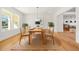 Cozy dining room with a wooden table set for eight, complemented by stylish decor and ample natural light at 5130 Travers Ln, Cumming, GA 30040
