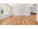 Open-concept dining area with hardwood floors and modern lighting, perfect for entertaining guests at 5130 Travers Ln, Cumming, GA 30040