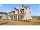 Beautiful two-story home with a brick facade, a covered porch, and a well-manicured lawn at 5130 Travers Ln, Cumming, GA 30040