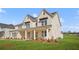 Beautiful two-story home with a brick facade, a covered porch, and a well-manicured lawn at 5130 Travers Ln, Cumming, GA 30040