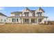 Beautiful two-story home with a brick facade, a covered porch, and a well-manicured lawn at 5130 Travers Ln, Cumming, GA 30040