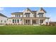 Beautiful two-story home with a brick facade, a covered porch, and a well-manicured lawn at 5130 Travers Ln, Cumming, GA 30040