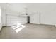 Spacious two car garage with overhead lighting, new garage door, and smooth concrete floors at 5130 Travers Ln, Cumming, GA 30040