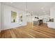 Open-concept living area with hardwood floors, a modern kitchen, and plenty of natural light at 5130 Travers Ln, Cumming, GA 30040