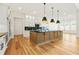 Modern kitchen featuring a large island, breakfast bar seating, and stainless steel appliances at 5130 Travers Ln, Cumming, GA 30040