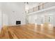 Bright living room with hardwood floors and a fireplace with a high ceiling at 5130 Travers Ln, Cumming, GA 30040