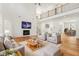 Bright living room with hardwood floors, fireplace, and access to a formal dining area at 5130 Travers Ln, Cumming, GA 30040