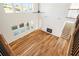 Open living room with fireplace, hardwood floors, staircase, and plenty of natural light at 5130 Travers Ln, Cumming, GA 30040