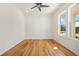 Modern office with a ceiling fan, hardwood floors and bright windows at 5130 Travers Ln, Cumming, GA 30040