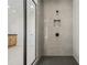 Contemporary shower with sleek gray tiling, a built-in niche, and modern fixtures at 5130 Travers Ln, Cumming, GA 30040