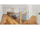 Hallway with wooden banister overlooking living room; and hardwood floors at 5130 Travers Ln, Cumming, GA 30040