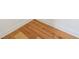A close up on the corner of a room showing the beautiful hardwood floors and clean baseboards at 5130 Travers Ln, Cumming, GA 30040