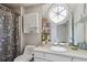 Charming bathroom featuring a large round mirror and unique window at 957 Piedmont Ne Ave # A, Atlanta, GA 30309