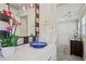 Elegant bathroom vanity with a vessel sink, modern lighting, and access to the hall at 957 Piedmont Ne Ave # A, Atlanta, GA 30309