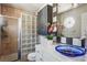Unique bathroom featuring a glass block shower, an oval window and blue glass vessel sink at 957 Piedmont Ne Ave # A, Atlanta, GA 30309