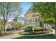 Exterior view of a charming yellow house with a spacious front yard and landscaping at 957 Piedmont Ne Ave # A, Atlanta, GA 30309