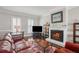Comfortable living room with fireplace, TV, and large windows offering natural light at 957 Piedmont Ne Ave # A, Atlanta, GA 30309