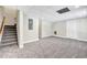 Finished basement features neutral walls, new carpet, and a staircase to the upper level at 1085 Crown River Pkwy, Mcdonough, GA 30252