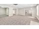 A finished basement with carpet and adjacent rooms with tile at 1085 Crown River Pkwy, Mcdonough, GA 30252
