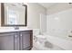 Bathroom featuring white tile flooring, dark vanity, and modern sink with updated fixtures at 1085 Crown River Pkwy, Mcdonough, GA 30252