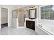 Bathroom featuring a tub, shower stall, vanity, and window providing natural light at 1085 Crown River Pkwy, Mcdonough, GA 30252