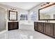 Elegant bathroom featuring dual vanities, a large tub, and tiled floors at 1085 Crown River Pkwy, Mcdonough, GA 30252