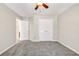 Bedroom featuring neutral walls, plush carpeting, ceiling fan, and closet with double doors at 1085 Crown River Pkwy, Mcdonough, GA 30252