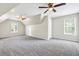 Bonus room features plush carpeting, modern fan, natural light, and neutral walls at 1085 Crown River Pkwy, Mcdonough, GA 30252