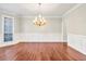 Classic dining room featuring hardwood floors, crown molding, and stylish chandelier at 1085 Crown River Pkwy, Mcdonough, GA 30252