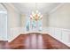 Elegant dining room with hardwood floors, chair rail molding, and a chandelier at 1085 Crown River Pkwy, Mcdonough, GA 30252