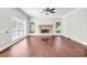 Bright living room featuring hardwood floors, a fireplace, and ample natural light from large windows at 1085 Crown River Pkwy, Mcdonough, GA 30252