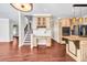 Spacious living area showcasing hardwood floors, recessed lighting and seamlessly connecting to the kitchen area at 1085 Crown River Pkwy, Mcdonough, GA 30252